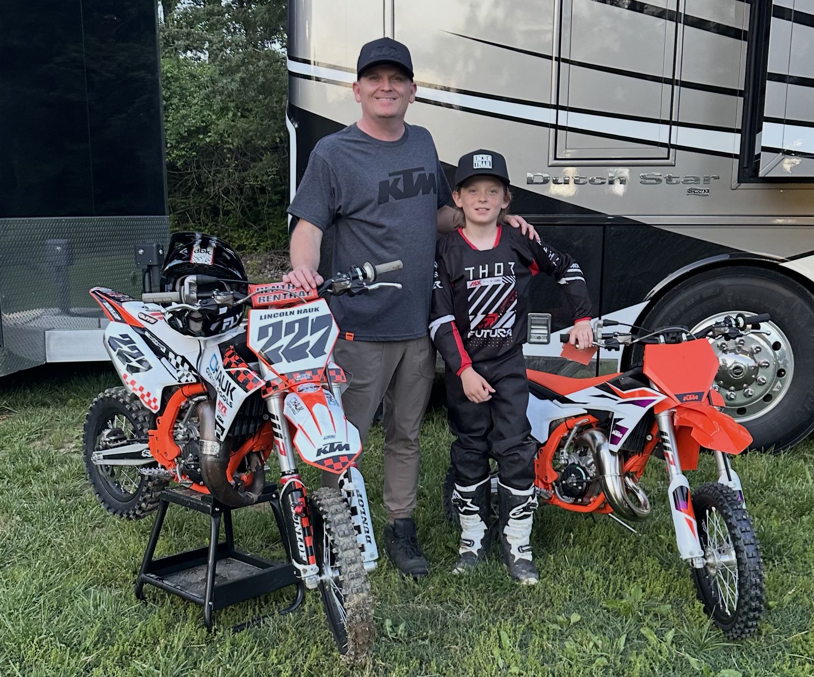 Jason Hauk, founder of H2O Simplified, with his son Lincoln and their KTM motocross bikes in front of a Newmar Dutch Star motorhome